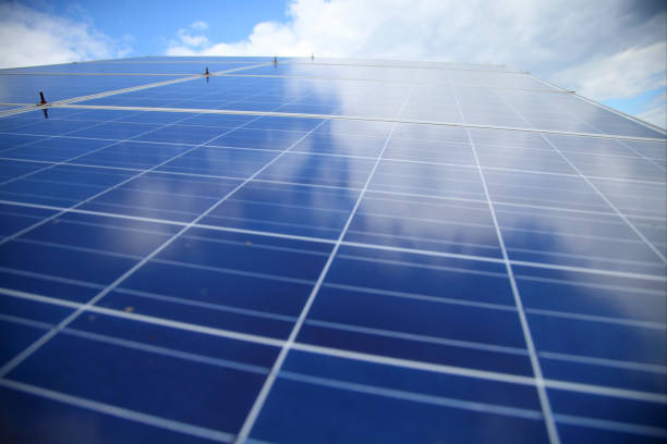 Close-up shot of blue solar panels, highlighting intricate textures and reflective surfaces