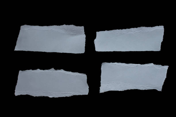 istock Ripped gray paper piece isolated on black background 1932125341