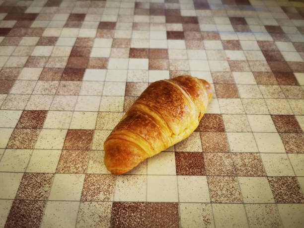 delicious croissant on a checkered table stock photo