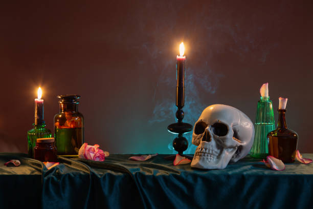istock scull and burning candles with halloween decor on dark background 1932144422