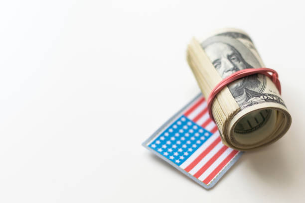 istock American Flag on a Bed of Dollar Bills. 1932155571
