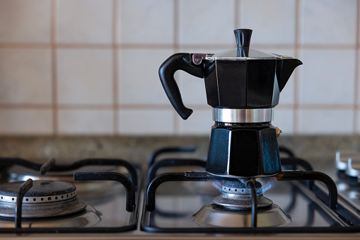 Making coffee with moka pot in the kitchen
