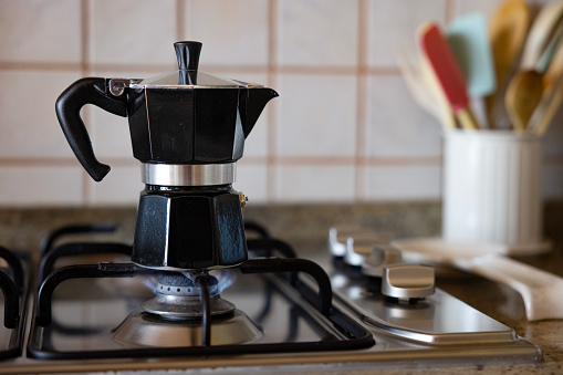 Making coffee with moka pot in the kitchen