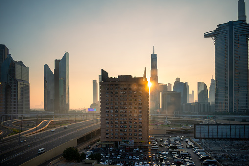 Dubai -UAE-Dec 21,2023: Road traffic conjunction and high rise building in Dubai view from top during sunrise