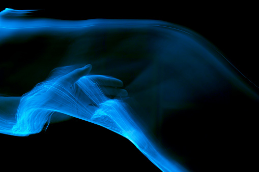Women Hand Touching Beam of Blue Light