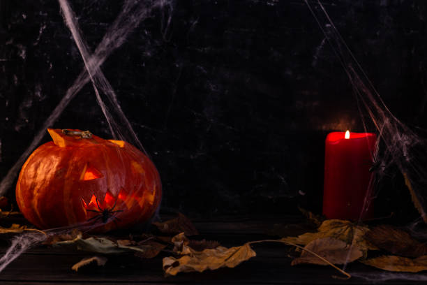 Halloween decorations, pumpkin and candles, spiders, Jack's lantern from pumpkin. High quality photo