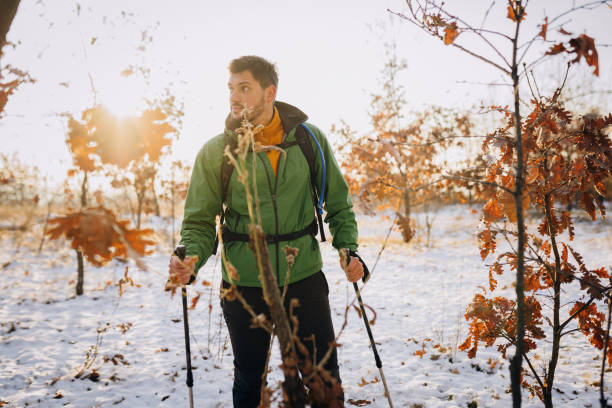 istock Young happy hiker man walking on snow 1932243779