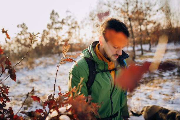 Young happy hiker man walking on snow