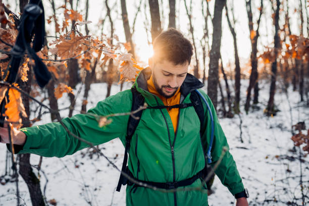 istock Young happy hiker man walking on snow 1932248150