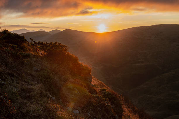 istock First rays of rising sun on the mountain range 1932249324