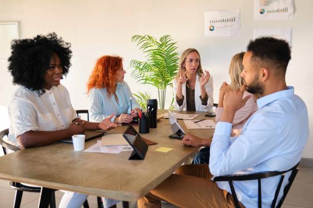 istock Diverse professional executive team working and brainstorming at a meeting. 1932250470