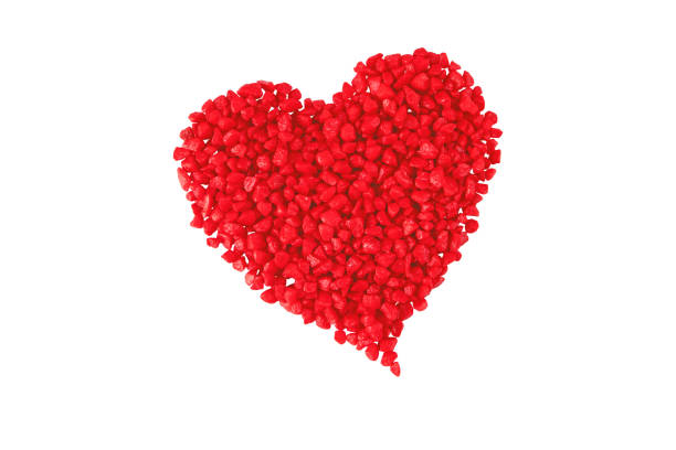 Red heart made of small decorative stones isolated on white. Saint Valentine's Day symbol of love, romance, warmth and happiness.\nFebruary 14 holiday design element.