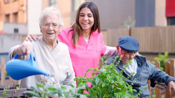 istock Nurse and senior people watering plants outdoors a nursing home 1932294655