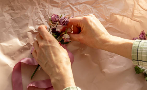 concept shot of the background theme, wrapping paper, dried roses other flowers and other arrangements. decoration - rose pattern yellow dried plant стоковые фото и изображения