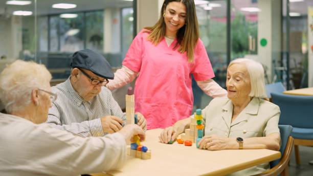 istock Friendly and funny nurse talking to senior people 1932296785