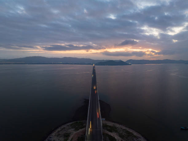 Drone view of Thi Nai bridge in sunrise  - Thi Nai lagoon, Quy Nhon city, Binh Dinh province, central Vietnam