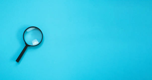 istock Magnifying alone with blue background with blank space for copy and place. 1932367935