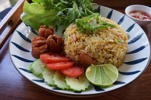 Homemade Fried Rice with Sausage served with vegetables and spicy fish sauce