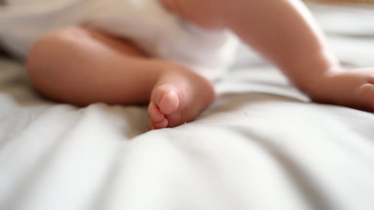 Close-up of baby feet and toes, cute baby sleeping peacefully in his crib at home.Independent sleep,childhood protection