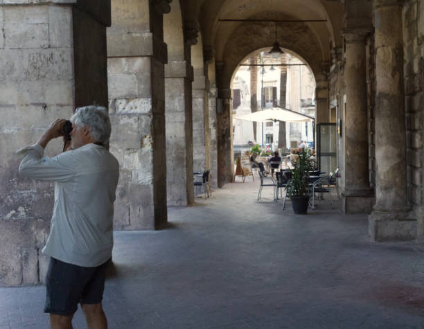 istock Senior man by a cafe in Modica, Sicily 1932431907