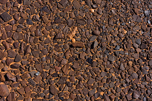 Rock Mosaic Background - Mosaic of flat rocks in sandy dirt in natural environment.