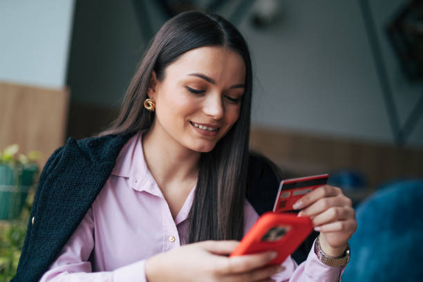 istock Woman using her credit card to pay the online purchase 1932461822