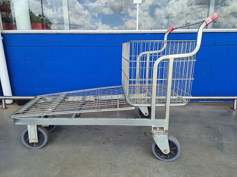 Large metal shopping cart, isolated. Side view