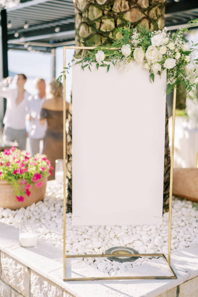 istock Blank sign on a counter near a palm tree on a restaurant terrace 1932511788