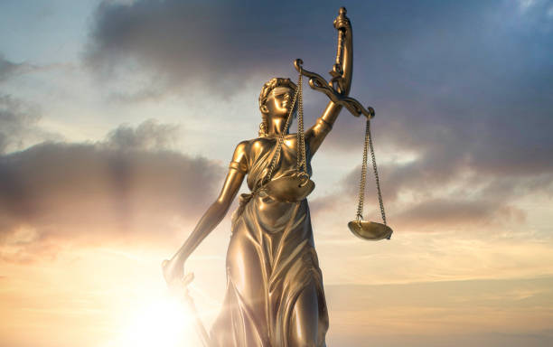 istock Statue of Justice with sunlight in the background 1932514449