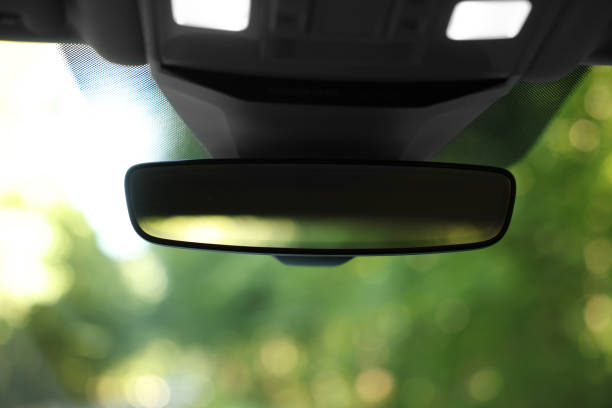 Clean rear view mirror in car, closeup