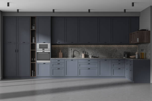istock Dark home kitchen interior cooking cabinet with kitchenware, concrete floor 1932519756