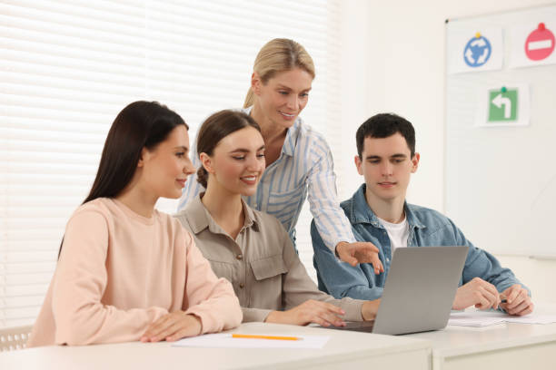 istock Happy teacher giving lesson in driving school 1932528193