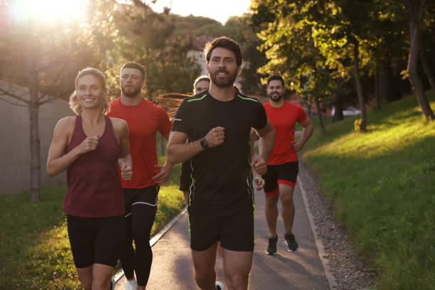 istock Group of people running outdoors on sunny day 1932547101