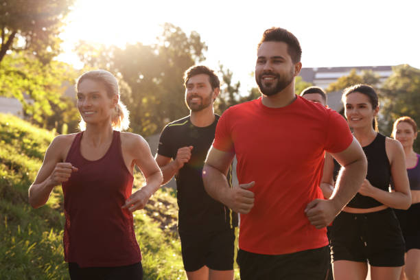 istock Group of people running outdoors on sunny day 1932547104
