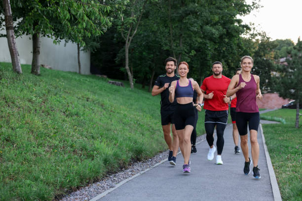 istock Group of people running outdoors. Space for text 1932547122