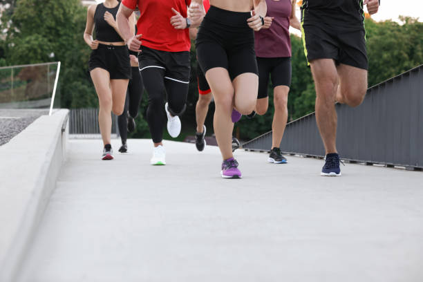 istock Group of people running outdoors, closeup view 1932547647