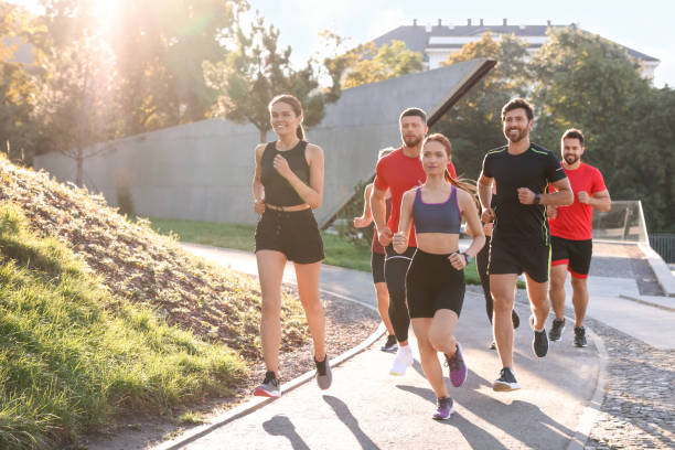 istock Group of people running outdoors on sunny day 1932548707