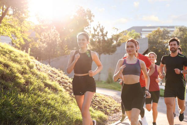 istock Group of people running outdoors on sunny day 1932548750