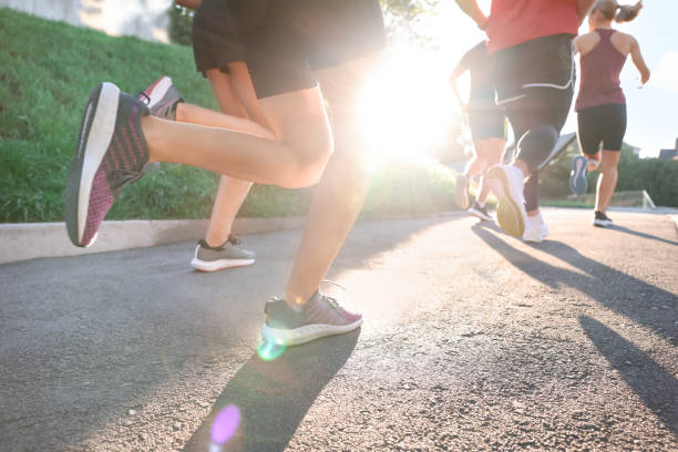istock Group of people running outdoors on sunny day, closeup 1932549279