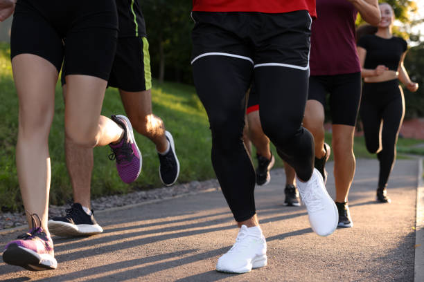 istock Group of people running outdoors, closeup view 1932549799