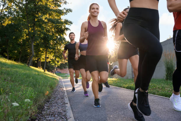 istock Group of people running outdoors on sunny day 1932550360