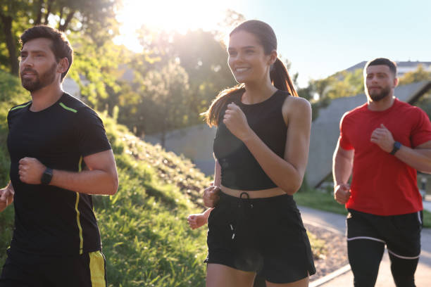 istock Group of people running outdoors on sunny day 1932551410