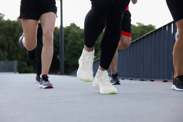 istock Group of people running outdoors, closeup view 1932551969