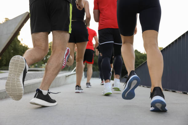 istock Group of people running outdoors, closeup view 1932551970