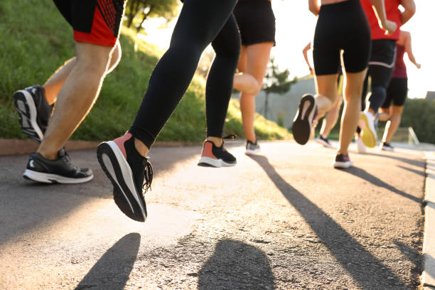 istock Group of people running outdoors on sunny day, closeup 1932553061