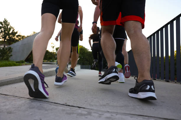 istock Group of people running outdoors, closeup view 1932553586