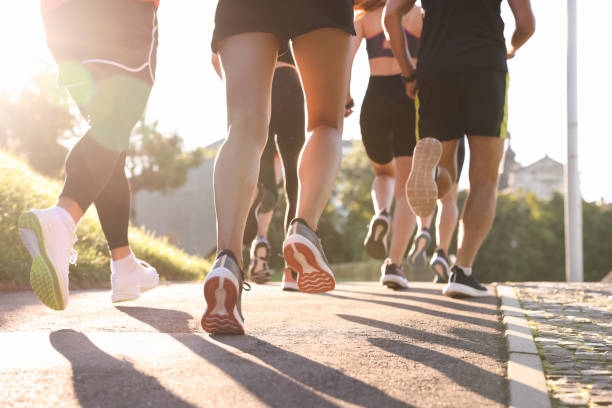 istock Group of people running outdoors on sunny day, closeup view 1932553588