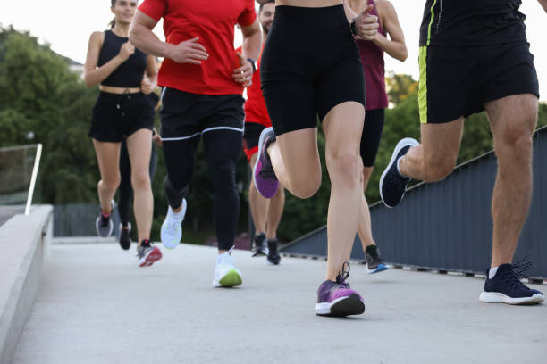 istock Group of people running outdoors, closeup view 1932553591