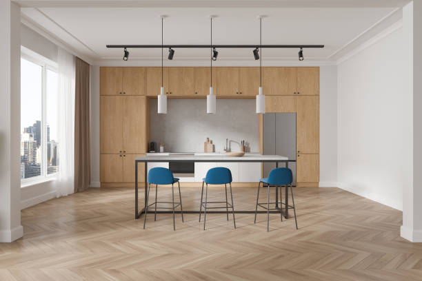 istock Stylish home kitchen interior with bar island, cooking cabinet and window 1932561600