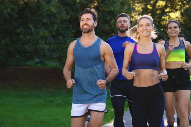 istock Group of people running in park. Active lifestyle 1932568551